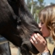 Karen Pery giving cuddles to a friendly horse during a leadership lesson