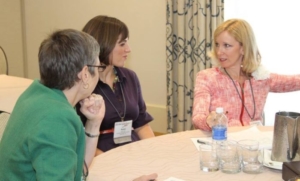Karen Pery and two other woman talking during a seminar