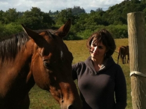 Karen Pery gently stroking a horse during a retreat