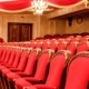 rows of red chairs with wooden trim